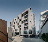 an apartment building with a car parked in front of it
