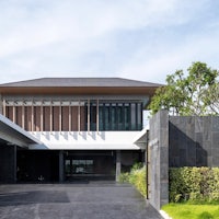 a modern house in thailand with a driveway